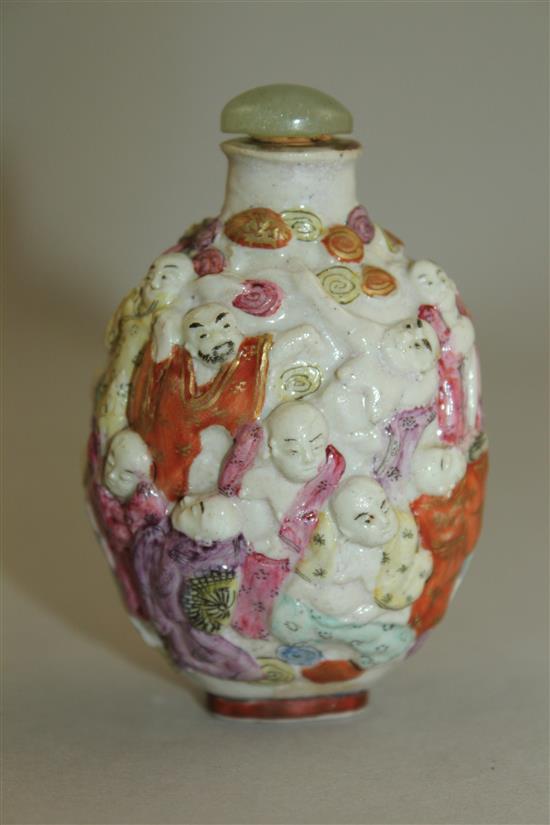 A Chinese moulded famille rose eighteen luohan snuff bottle, Qianlong seal mark, 1820-1850, 7.4cm